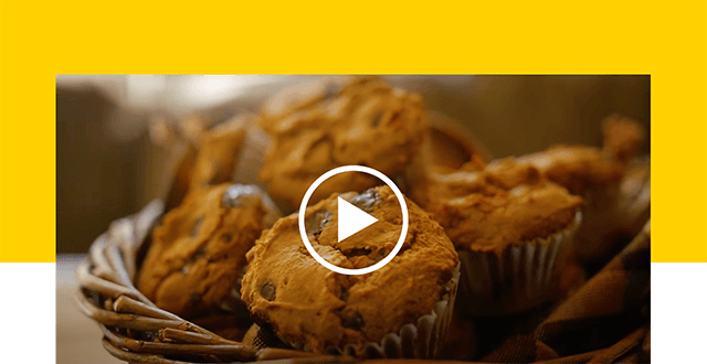 Pumpkin muffins with a play button on top.
