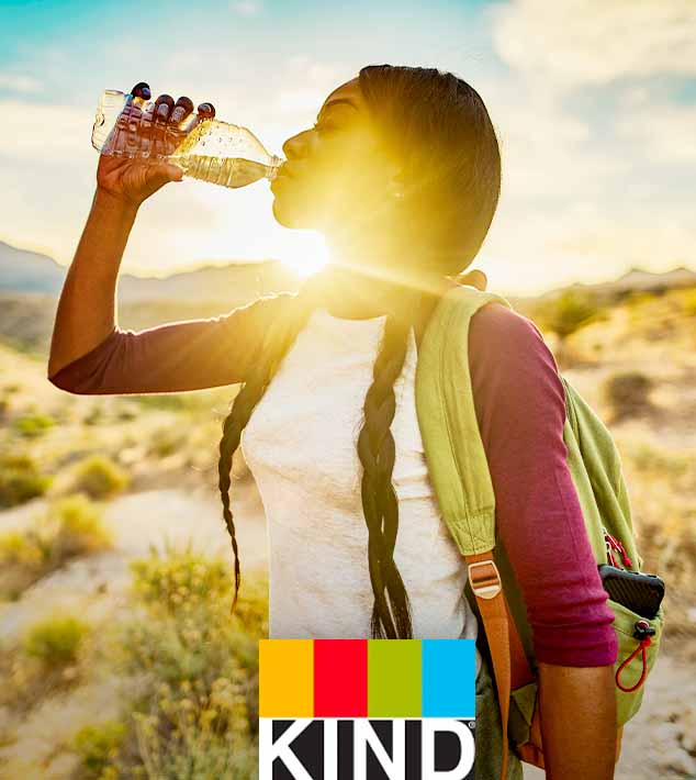 KIND Bar logo. A woman drinking a water bottle.