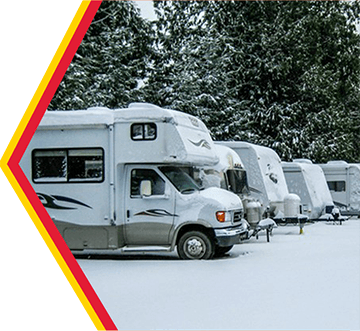 RVs covered in snow.