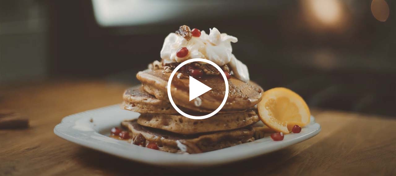 Play button on top of gingerbread pancakes.