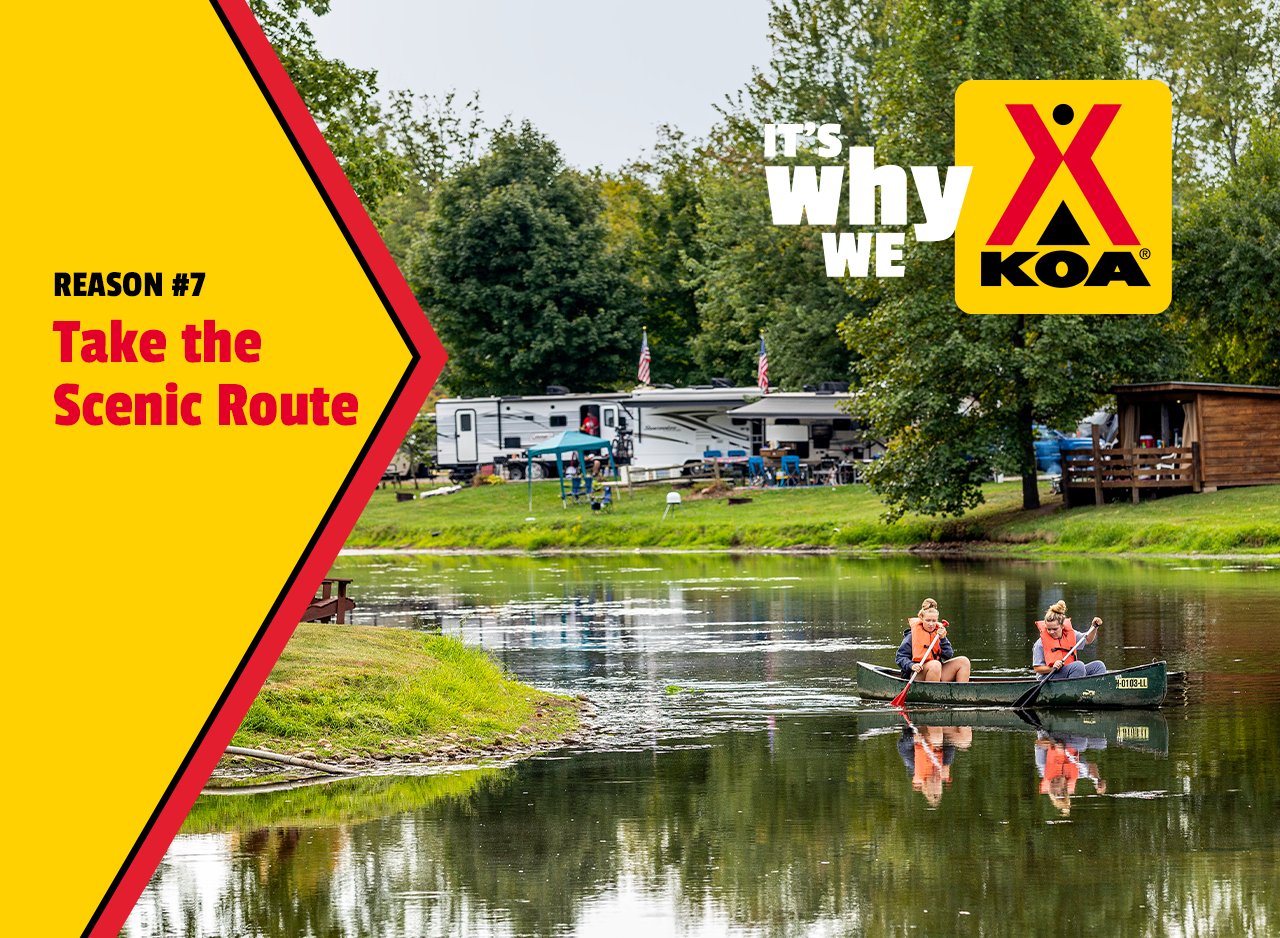 Two girls paddling in a canoe on a river at a KOA campground. RVs are parked in the background. A headline reads: Reason #7 Take the Scenic Route, it's why we KOA