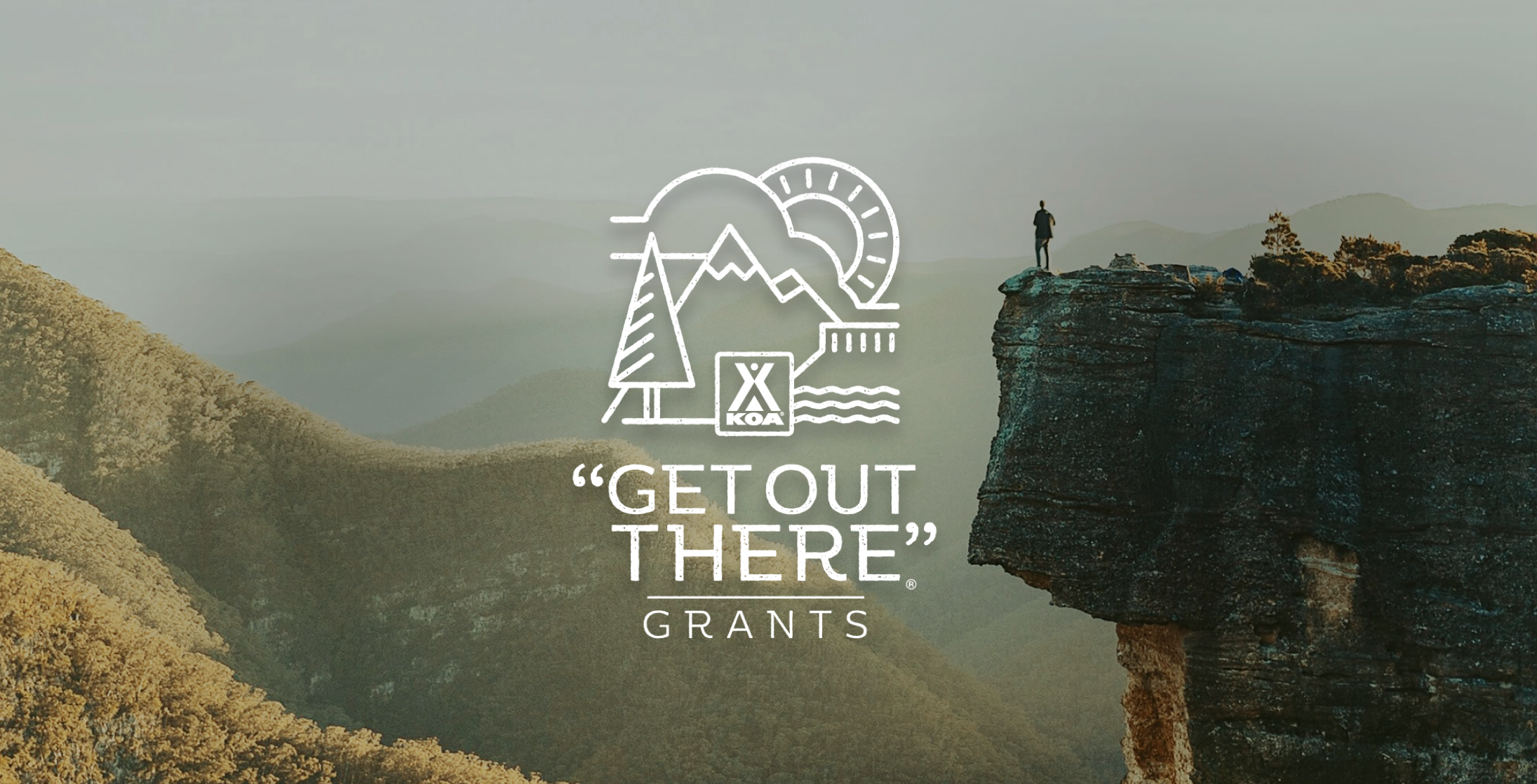 A hiker on the edge of a cliff overlooking a hilly landscape. A logo reads "Get Out There" Grants.