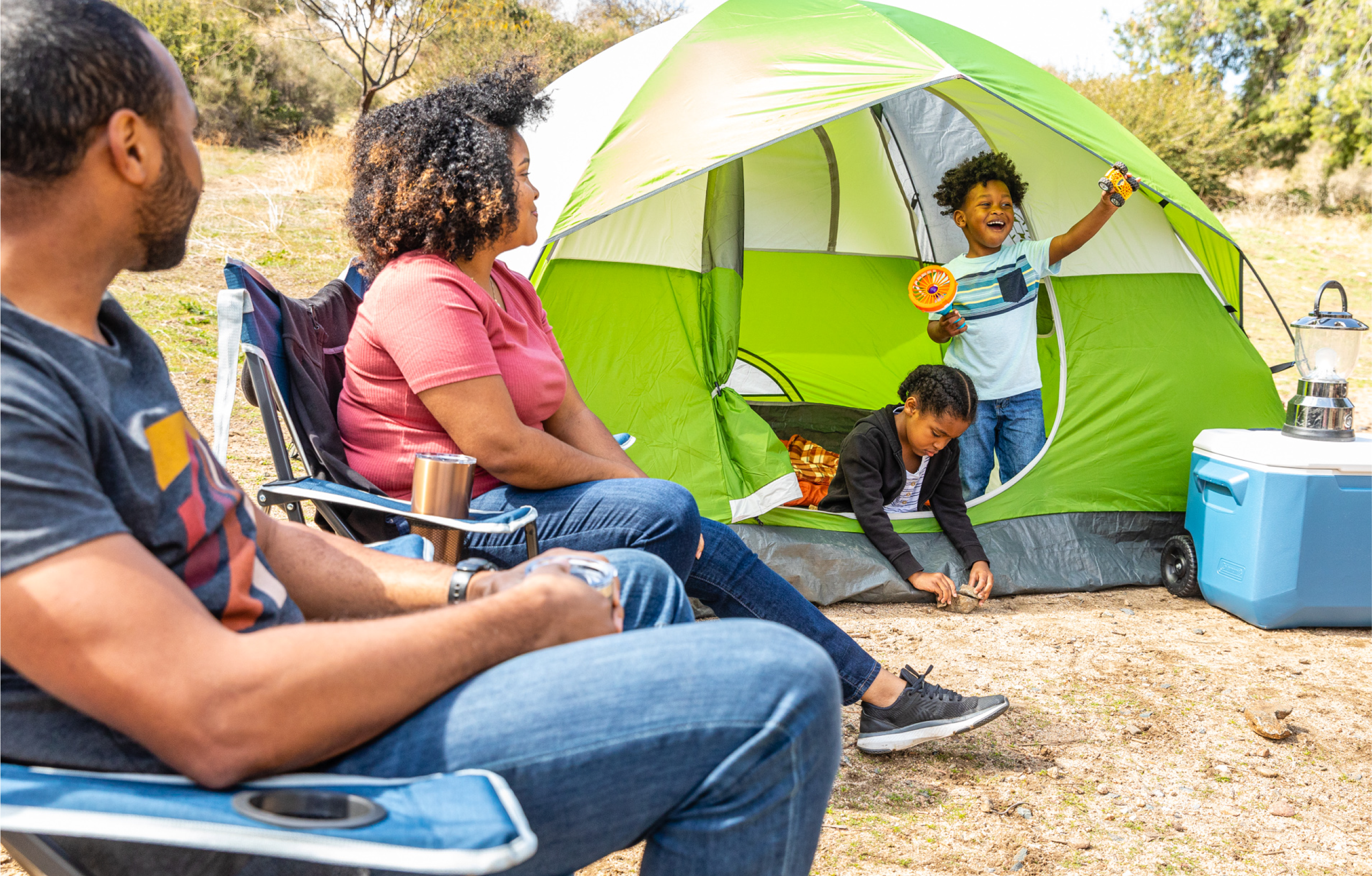 A family enjoying the day at a KOA tent site.